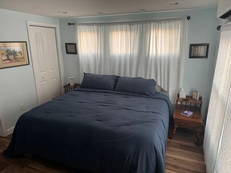Lodge bedroom with blue bedding and curtained windows