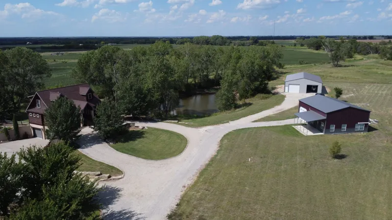 Aerial view of the ranch buildings, pond and surrounding fields